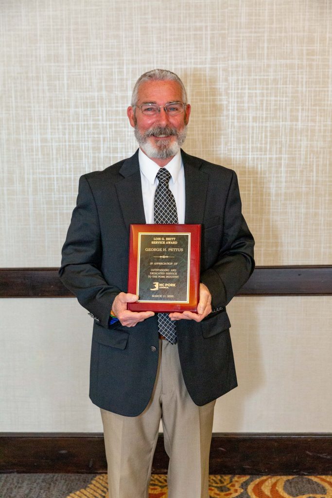 George Pettus holding Lois Britt Service Award
